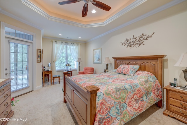 carpeted bedroom featuring access to outside, crown molding, a tray ceiling, and ceiling fan