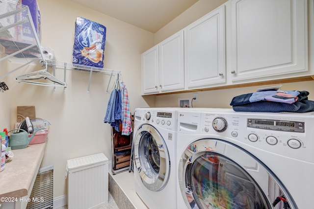 laundry area featuring cabinets and washing machine and dryer