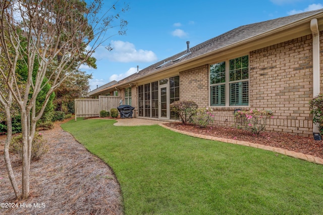 rear view of property with a yard