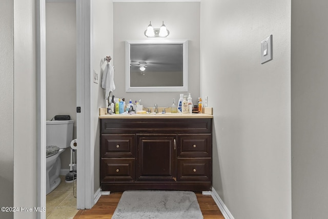 bathroom featuring vanity, hardwood / wood-style flooring, and toilet