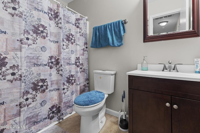 bathroom featuring tile patterned flooring, vanity, curtained shower, and toilet