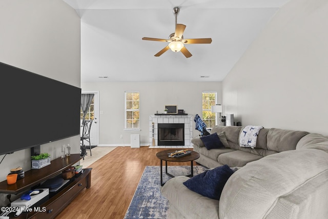 living room featuring ceiling fan, high vaulted ceiling, and light hardwood / wood-style flooring