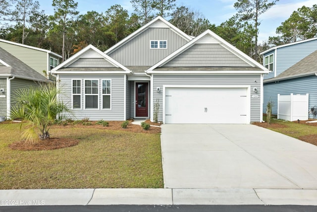 craftsman-style house with a garage and a front lawn