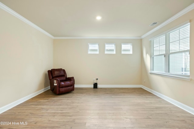 unfurnished room with light hardwood / wood-style floors and crown molding