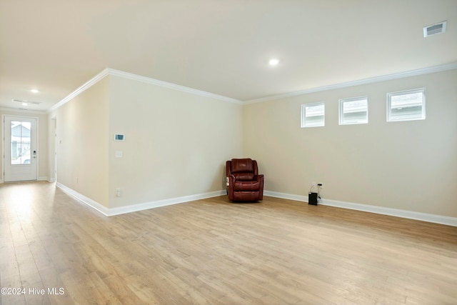 unfurnished room featuring light hardwood / wood-style floors and ornamental molding