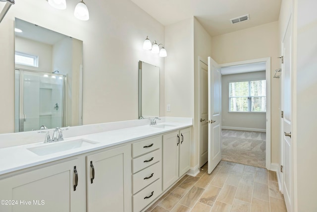 bathroom featuring an enclosed shower, hardwood / wood-style floors, vanity, and a wealth of natural light