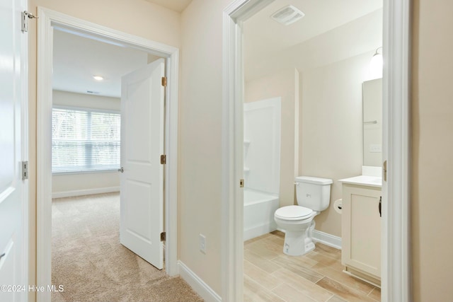 bathroom with vanity, hardwood / wood-style flooring, and toilet