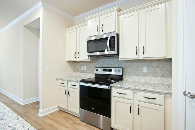 kitchen featuring crown molding, decorative backsplash, light wood-type flooring, light stone counters, and stainless steel appliances