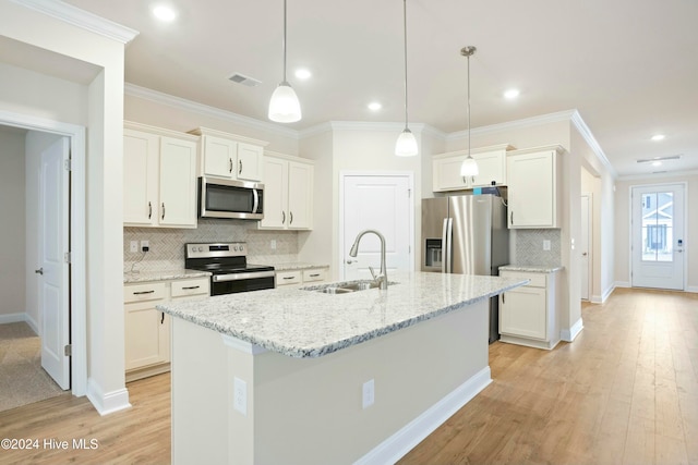 kitchen featuring sink, white cabinets, an island with sink, and appliances with stainless steel finishes