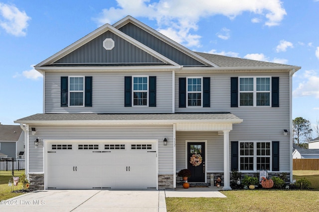 craftsman-style home with a garage and a front lawn