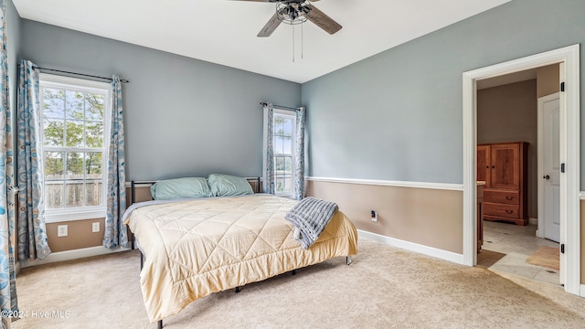 bedroom with ceiling fan and light colored carpet