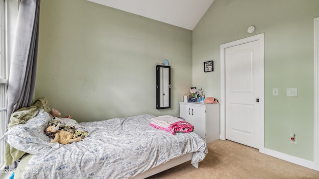 carpeted bedroom featuring lofted ceiling