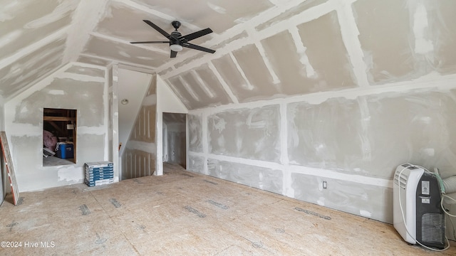 unfurnished living room with ceiling fan and lofted ceiling