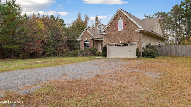 front facade with a front yard and a garage