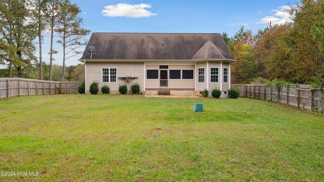 back of property featuring a yard