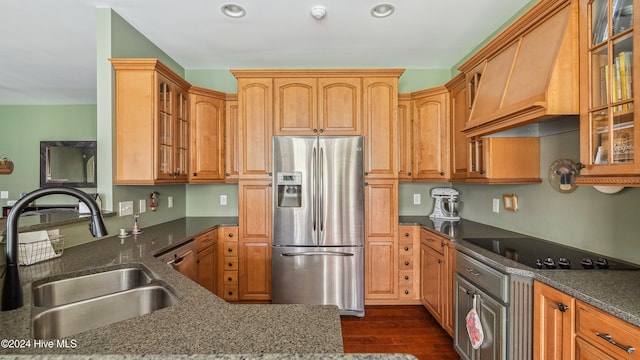 kitchen with black electric stovetop, custom range hood, sink, stainless steel fridge with ice dispenser, and dark hardwood / wood-style floors