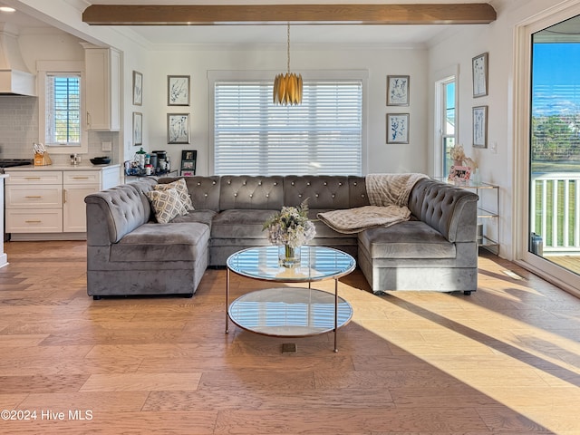 living room with a wealth of natural light and beamed ceiling