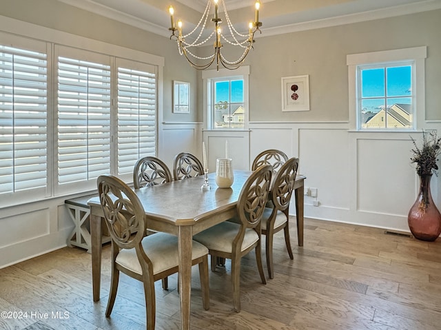 dining room featuring a chandelier, crown molding, and light hardwood / wood-style flooring