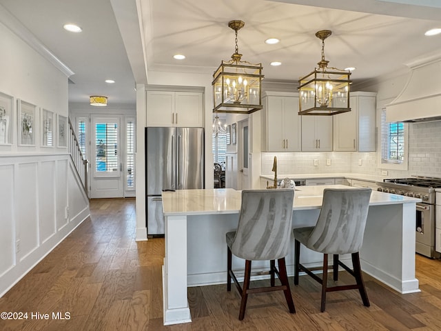 kitchen featuring pendant lighting, dark hardwood / wood-style floors, a center island, and appliances with stainless steel finishes