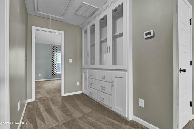 hallway with dark colored carpet