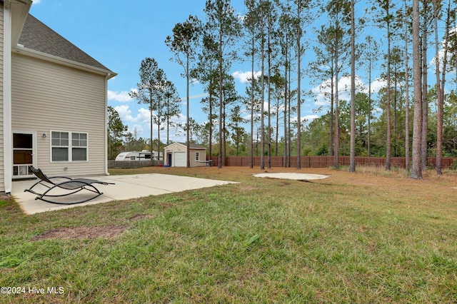 view of yard featuring a patio area and an outdoor structure