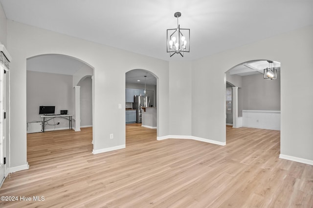 interior space with an inviting chandelier and light hardwood / wood-style flooring