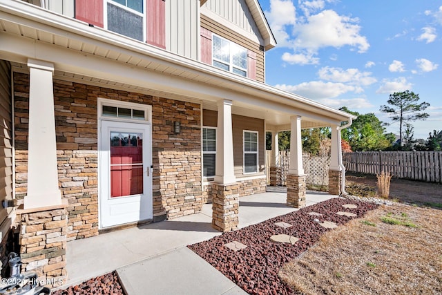 view of exterior entry with covered porch