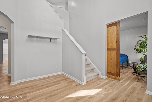 stairs with hardwood / wood-style floors