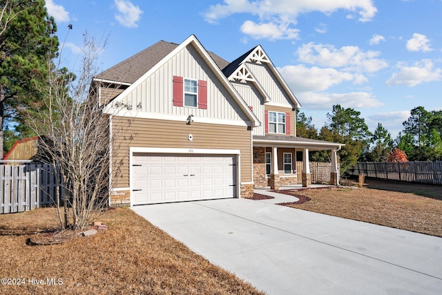 view of front of home featuring a porch and a garage