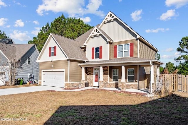 craftsman house with a porch, a garage, and a front yard