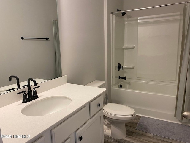 full bathroom with hardwood / wood-style flooring, vanity,  shower combination, and toilet