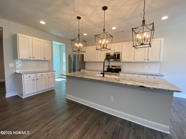 kitchen featuring pendant lighting, dark hardwood / wood-style flooring, stainless steel appliances, and white cabinetry