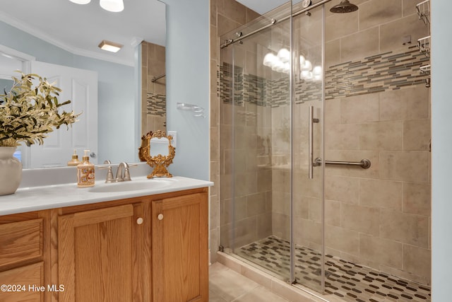 bathroom with vanity, a shower with door, tile patterned flooring, and ornamental molding