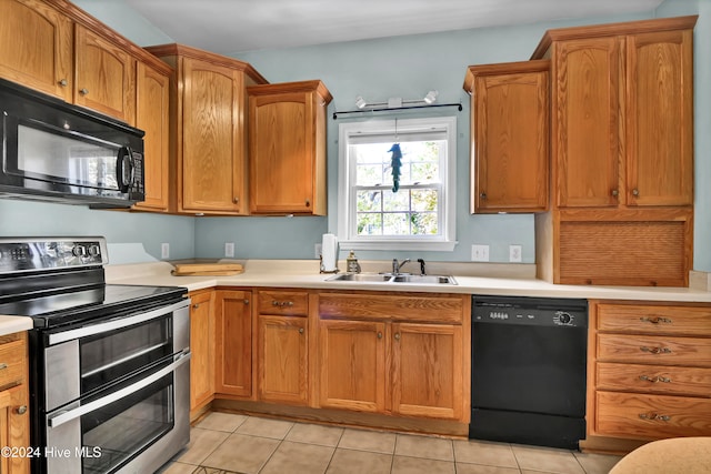 kitchen with sink, light tile patterned flooring, and black appliances