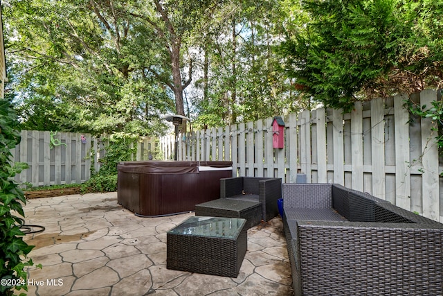 view of patio / terrace featuring an outdoor hangout area and a hot tub