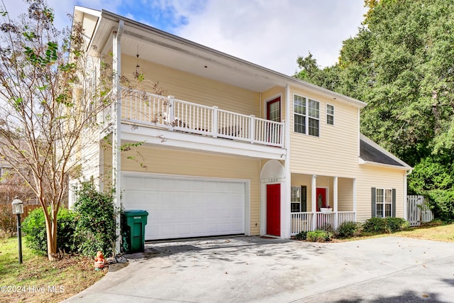 view of front facade featuring a garage and a balcony