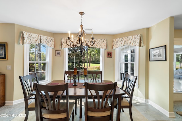 tiled dining room with plenty of natural light and a notable chandelier