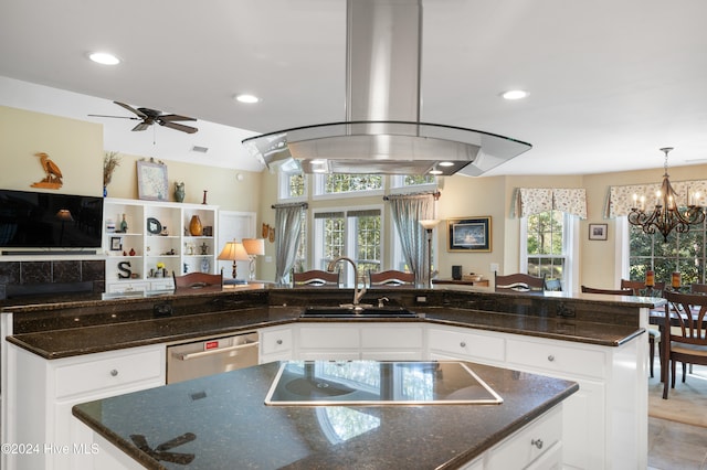 kitchen with white cabinets, island range hood, stainless steel dishwasher, and sink