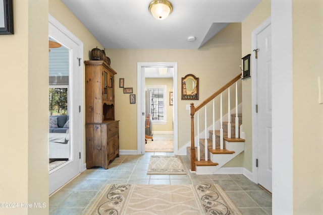 foyer entrance with light tile patterned flooring