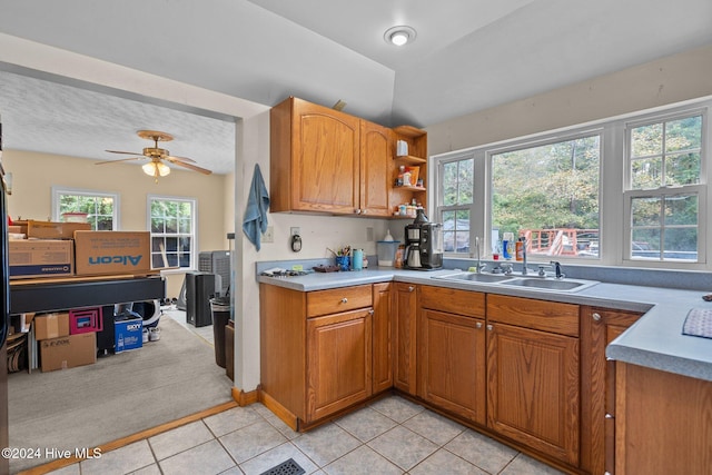 16200 US Highway 421, Burgaw, NC 28425 - kitchen featuring a sink, light tile patterned floors, ceiling fan, brown cabinetry, and light countertops