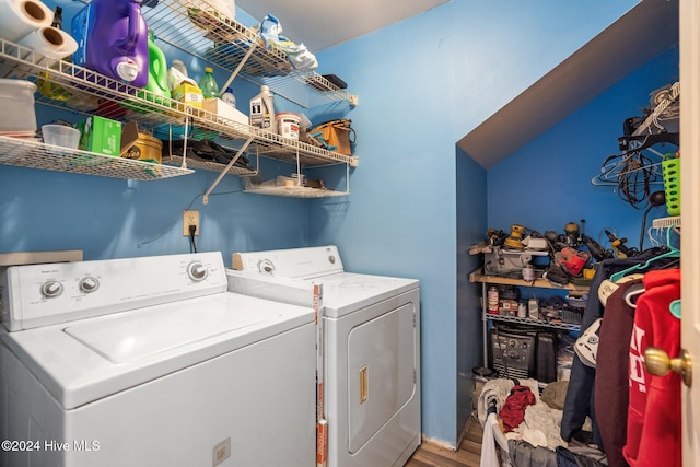 clothes washing area featuring separate washer and dryer and wood-type flooring