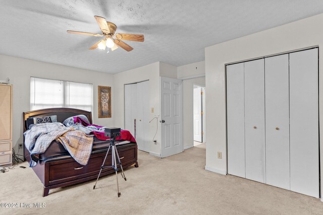 16200 US Highway 421, Burgaw, NC 28425 - carpeted bedroom with two closets, a textured ceiling, a ceiling fan, and baseboards