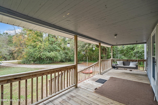 deck with a yard and a porch