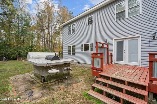 rear view of house with a deck and french doors