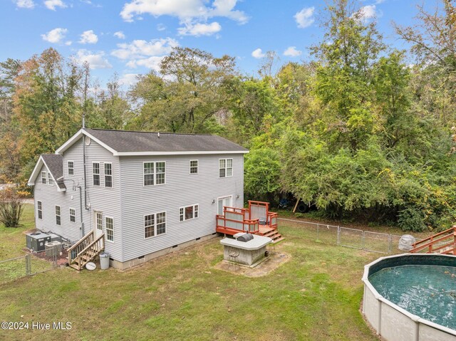 16200 US Highway 421, Burgaw, NC 28425 - rear view of house featuring a wooden deck, crawl space, a shingled roof, an outdoor pool, and view of wooded area