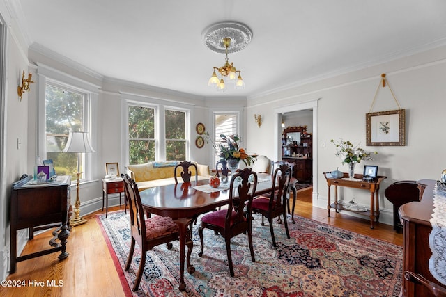 505 Broad St, Oriental, NC 28571 - dining space featuring a chandelier, light wood-style flooring, crown molding, and baseboards