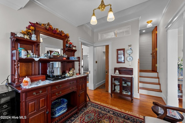 interior space featuring ornamental molding and light hardwood / wood-style flooring