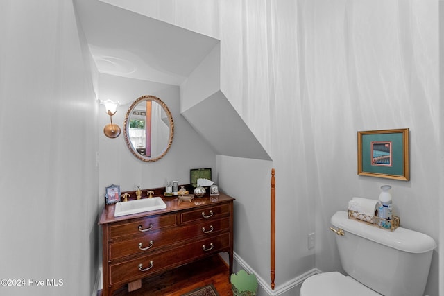 bathroom featuring hardwood / wood-style floors, vanity, and toilet