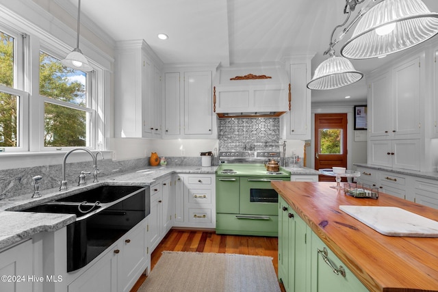 505 Broad St, Oriental, NC 28571 - kitchen with range with electric cooktop, wooden counters, a sink, white cabinetry, and decorative backsplash