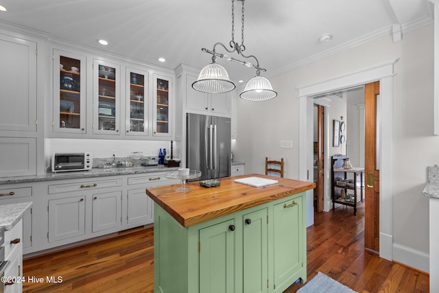 kitchen featuring stainless steel refrigerator, a center island, wood counters, dark hardwood / wood-style flooring, and white cabinets